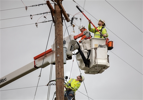 Electric line technicians restoring power.