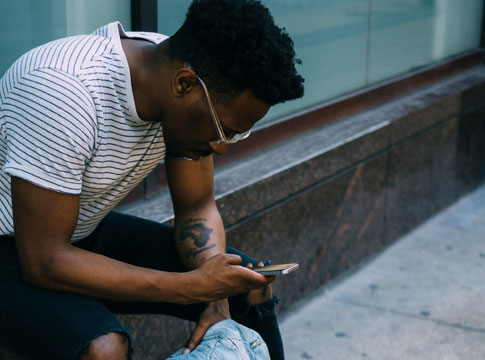 Man sitting outside with cell phone