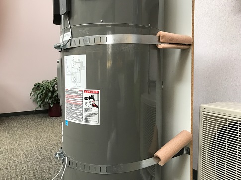Picture of a hot water heater strapped to the wall