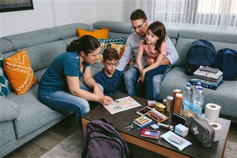 family sitting around table planning for emergency