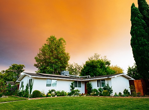 Home with solar panels and an orange sunset