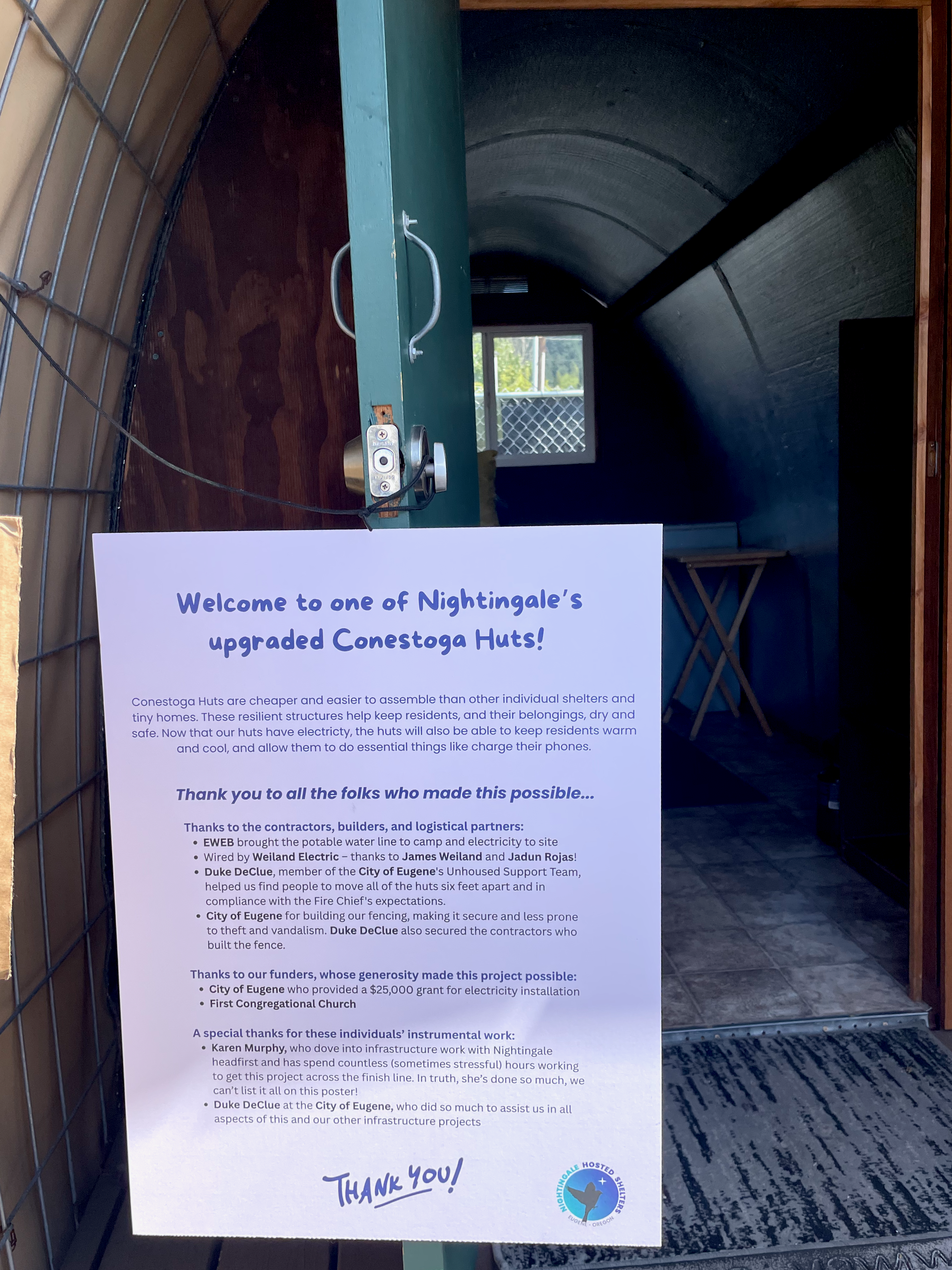 Poster welcoming guests into one of the Nightingale Hosted Shelters upgraded Conestoga Huts