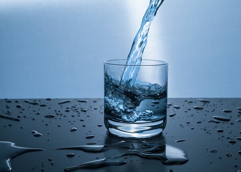 picture of a glass being filling with drinking water