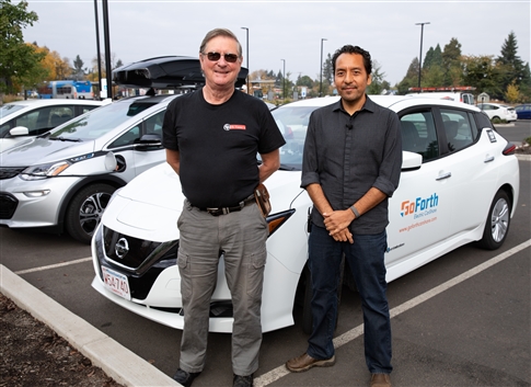 EWEB staff and partner pose with Electric Car