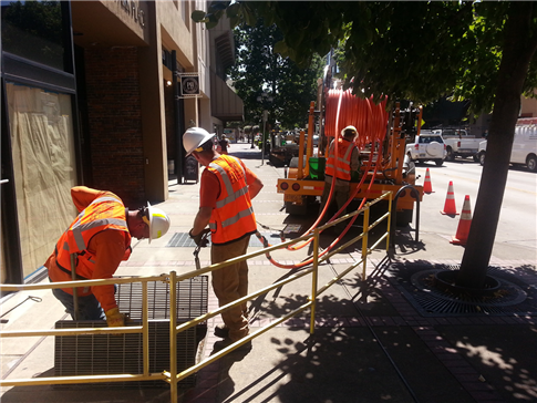 Crews installing fiber conduit in downtown Eugene