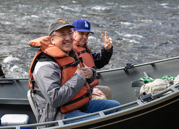 EWEB Commissioner John Barofsky gives a thumbs up from a drift boat on the McKenzie River