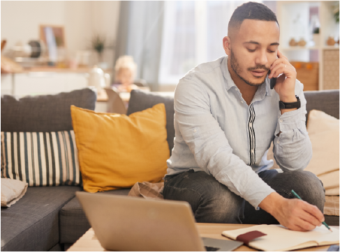 Man talking on the phone and jotting notes