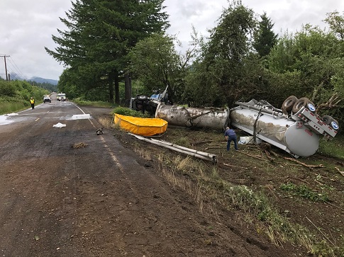 picture of overturned tanker truck on McKenzie Highway with fuel spilled in the roadway