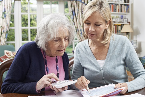 Picture of two women looking over bills