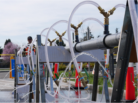 Hoses for filling water jugs at one of EWEB's emergency water stations