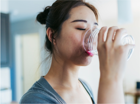 Woman enjoying a glass of tap water