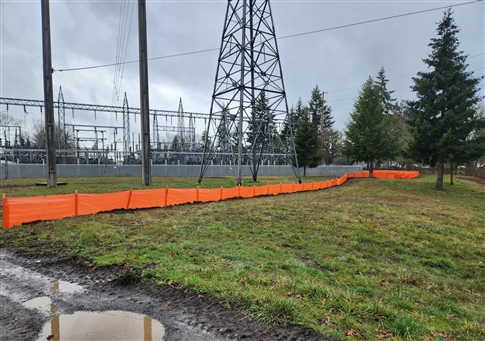 Photo of an orange erosion fence around the substation