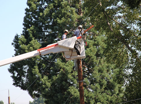 Crews remove a crossarm as past of a reliability improvement project