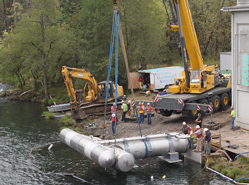 Workers use a large crane to place a new intake until in the McKenzie River near water filtration plant