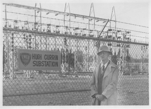 Hugh Currin stands in front of the Currin Substation in the 1960s