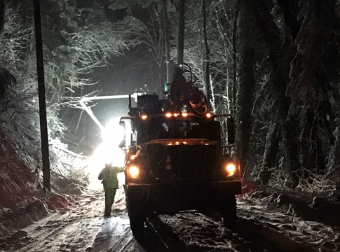 Line repair crews working in the snow at night