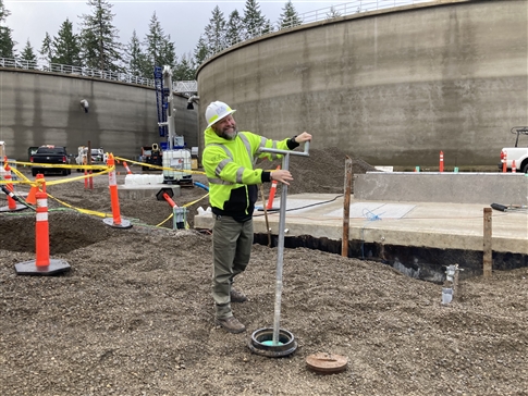 EWEB water operations staff turns the valve to put new water tanks into service