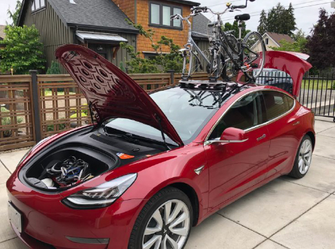 Red Tesla Model 3 parked in front of Eugene home