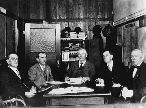 EWEB's first five board of commissioners sitting around a table.