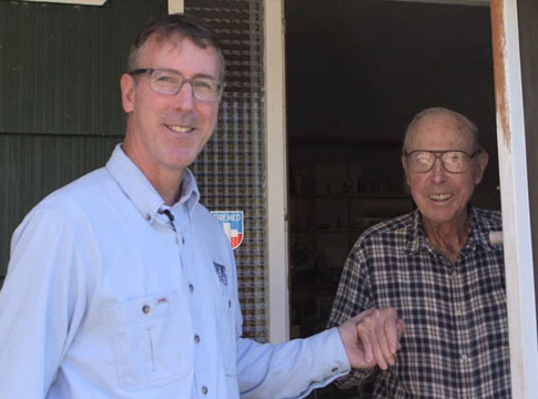 General Manager Frank Lawson standing with his father.