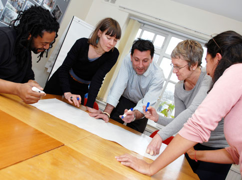 Group of people working together around a table.