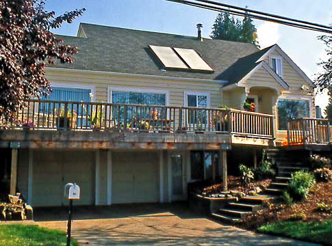 Home with two solar panels on rooftop.