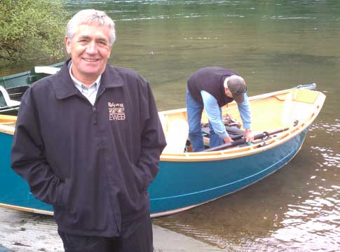 Commissioner John Brown standing in front of a drift boat.