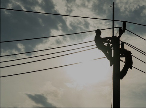 Line technicians working on a power pole