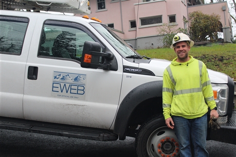 Line workers in front of EWEB service truck