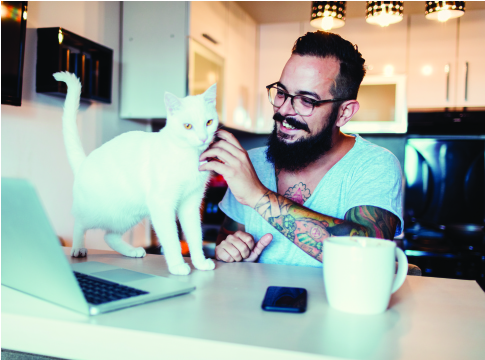 man with beard and tatoos petting a cat