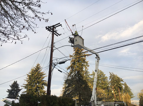 Line crew repairs overhead power line