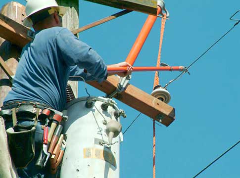 Electric line technician restoring power.