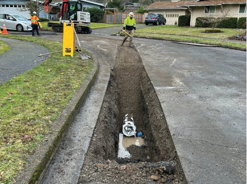 Exposed water pipe in road trench