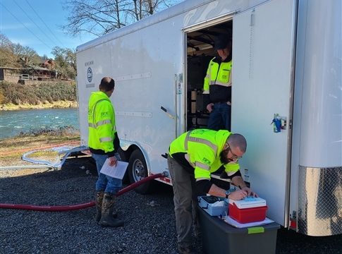 water treatment trailer and three male workers