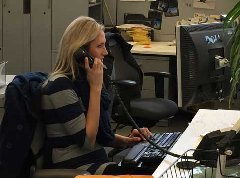 Woman at desk on the phone