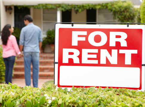 For rent sign with a couple holding hands in the background.