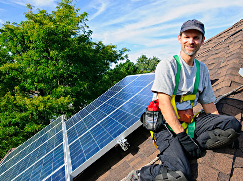 Man on roof with solar panels